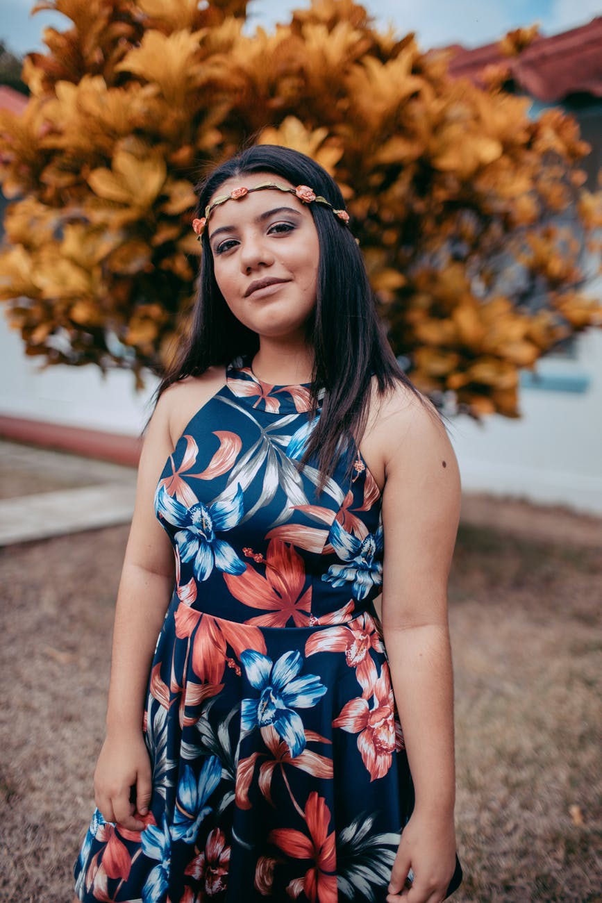 photo of smiling woman in floral dress