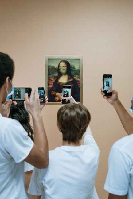people taking picture of mona lisa painting with face mask